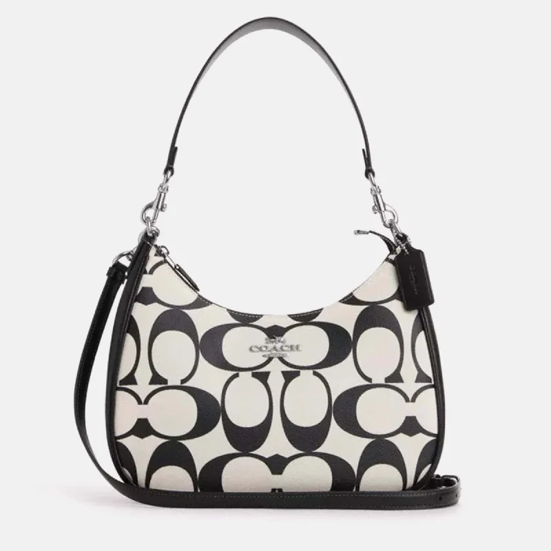 Coach Rogue bags featuring the signature C - hardware for a branded lookBlack/White leather Teri Hobo In Signature Canvas