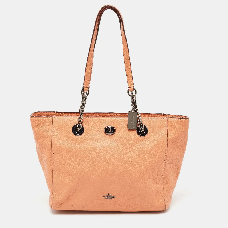 Ladies Coach Tabby bags with a textured leather surface for a more tactile lookPeach Leather Turnlock Chain Tote