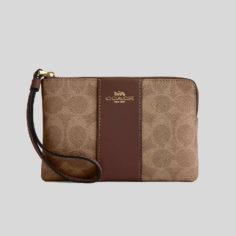 Coach Rogue bags featuring the signature C - hardware for a branded lookCOACH Corner Zip Wristlet In Signature Canvas With Stripe Tan/Brown CW854