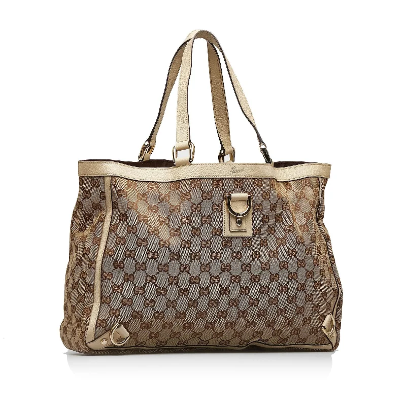 Women Gucci bags with a snap - button closure and a decorative charmGucci Abbey GG Canvas Tote (KlNn76)