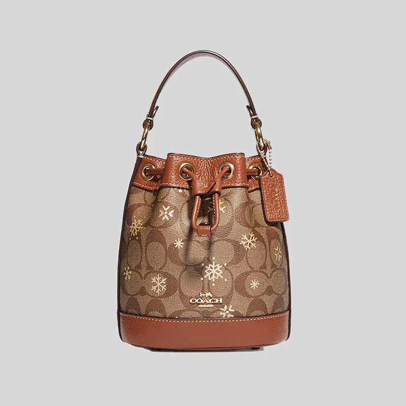 Ladies Coach Rogue bags with a star - shaped charm for a playful touchCOACH Dempsey Drawstring Bucket Bag 15 In Signature Canvas With Snowflake Print Khaki Multi CE587